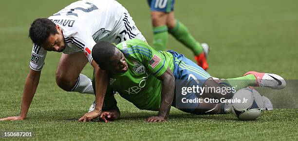 Eddie Johnson of the Seattle Sounders FC battles Jun Marques Davidson of the Vancouver Whitecaps at CenturyLink Field on August 18, 2012 in Seattle,...