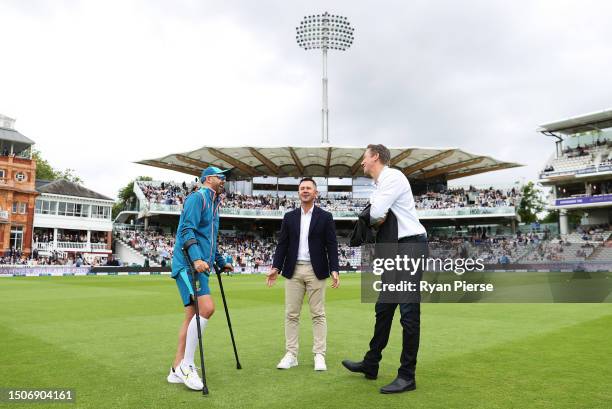 Nathan Lyon of Australia is seen while on crutches after sustaining an injury on Day Two speaking to Ricky Ponting and Glenn McGrath prior to Day...