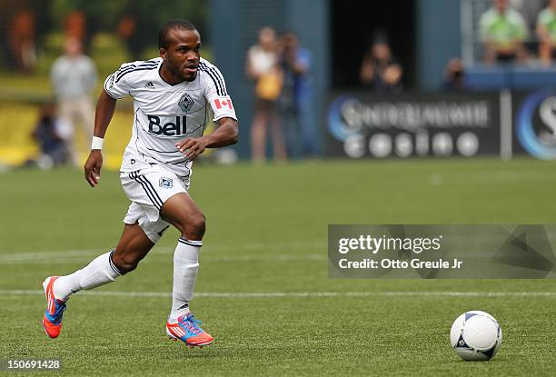 Dane Richards of the Vancouver Whitecaps dribbles against the Seattle Sounders FC at CenturyLink Field on August 18, 2012 in Seattle, Washington.