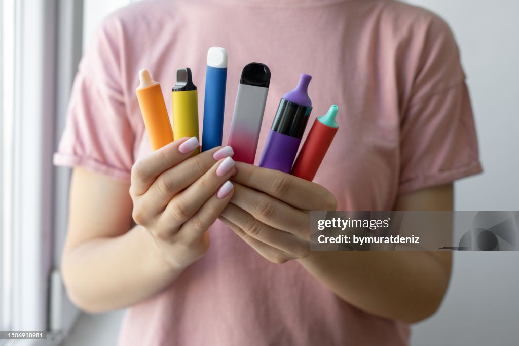 Vape cigarettes in woman hand