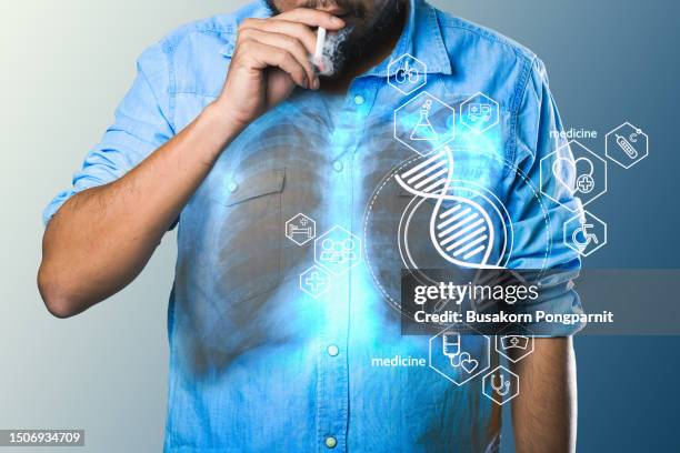 detail of a man holding a smoking cigarette in his hand. medical digital technology. - passive smoking stock pictures, royalty-free photos & images