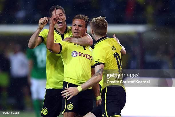 Mario Goetze celebrates the second goal with Robert Lewandowski and Marco Reus of Dortmund during the Bundesliga match between Borussia Dortmund and...