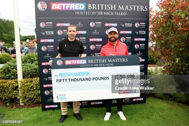 Matthew Baldwin of England and Matt Holdstock, Partnership Development Manager for Prostate Cancer UK pose for a photo with a cheque for £50,000 from...