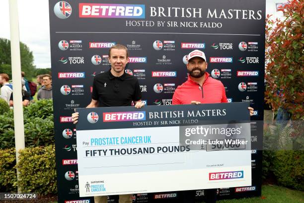 Matthew Baldwin of England and Matt Holdstock, Partnership Development Manager for Prostate Cancer UK pose for a photo with a cheque for £50,000 from...