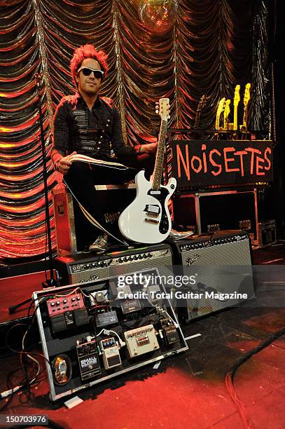 Portrait of Dan Smith, guitarist with English indie rock group Noisettes, posing with his DiPinto Mach IV guitar in the Bristol Anson Rooms on...