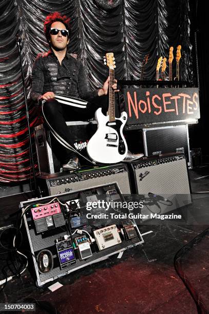 Portrait of Dan Smith, guitarist with English indie rock group Noisettes, posing with his DiPinto Mach IV guitar in the Bristol Anson Rooms on...