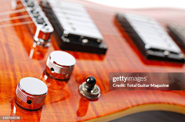 Detail of a Michael Kelly Vex Exotic X electric guitar with a Tiger Eye finish, taken on December 14, 2009.