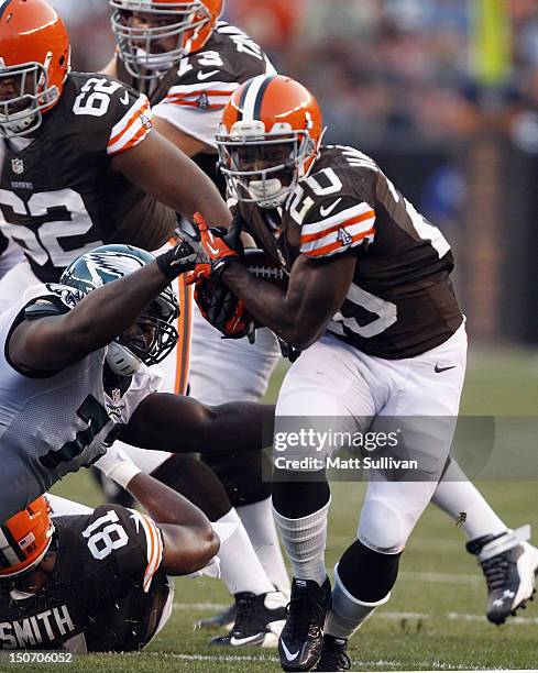 Running back Montario Hardesty of the Cleveland Browns runs by tackle Demetress Bell of the Philadelphia Eagles at Cleveland Browns Stadium on August...