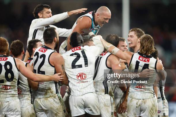 Dan Houston of the Power celebrates kicking the winning goal after the final siren during the round 16 AFL match between Essendon Bombers and Port...