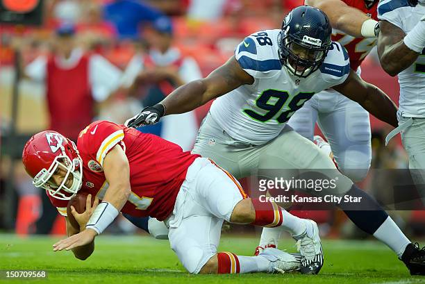 Kansas City Chiefs quarterback Matt Cassel, lef, is sacked on the team's first offensive possession by Seattle Seahawks defensive end Greg Scruggs in...