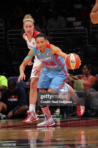 Armintie Price of the Atlanta Dream drives against Natasha Novosel of the Washington Mystics at the Verizon Center on August 24, 2012 in Washington,...