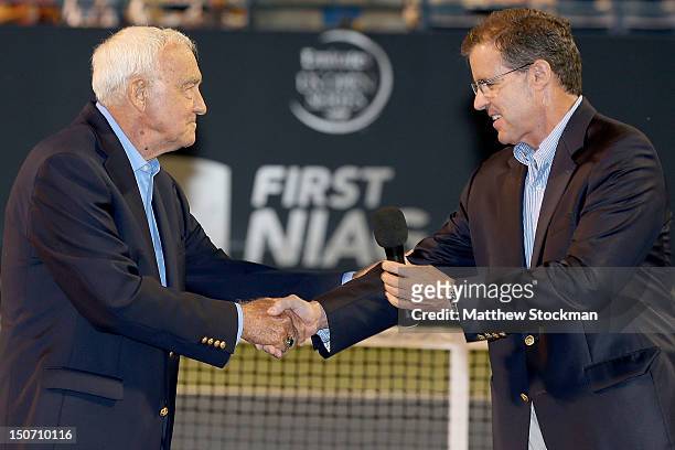 Mike Davies is presented a ring by Mark Stenning, CEO of the International Tennis Hall of Fame, commemorating his induction into the International...