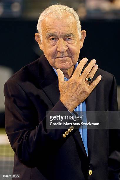 Mike Davies poses for photographers after being presented a ring commemorating his induction into the International Tennis Hall of Fame during the...