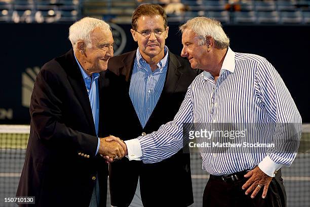 Mike Davies shales hands with Butch Buchholz , Chaiman of the New Haven Open at Yale, after being presented a ring by Mark Stenning , CEO of the...