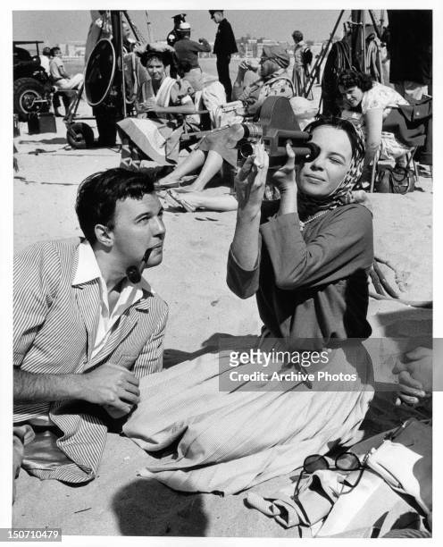 Distinguished young London and Broadway director Peter Hall enjoying the California sunshine with Leslie Caron on location for the film 'Gigi', 1958.