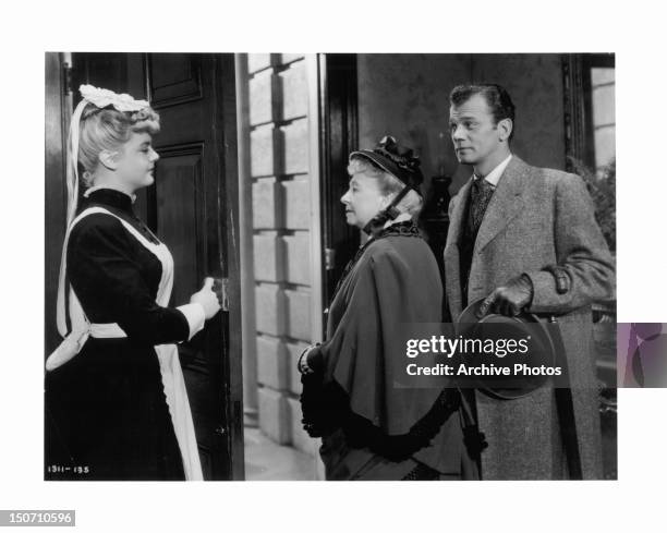 Angela Lansbury opens the door for Dame May Whitty and Joseph Cotten in a scene from the film 'Gaslight', 1944.