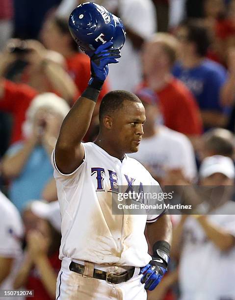Adrian Beltre of the Texas Rangers acknowledges the crowd after hitting a single to complete a cycle against the Minnesota Twins at Rangers Ballpark...