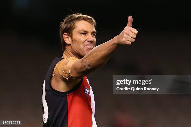 Shane Warne celebrates kicking a goal during the St Kilda Thank You Round charity match at Etihad Stadium on August 25, 2012 in Melbourne, Australia.