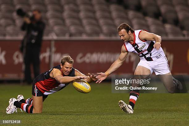 Shane Warne and Aaron Hamill contest for the ball during the St Kilda Thank You Round charity match at Etihad Stadium on August 25, 2012 in...