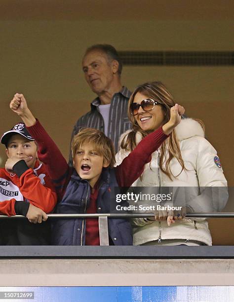 Elizabeth Hurley and her son Damian Hurley along with Keith Warne watch as Shane Warne plays a game of Aussie Rules football as he takes part in the...