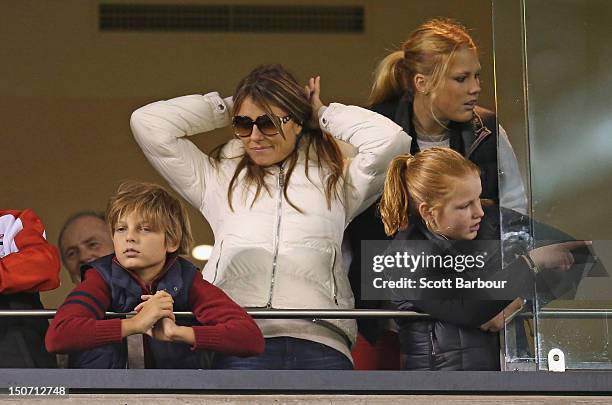 Elizabeth Hurley and her son Damian Hurley along with Brooke Warne and Summer Warne watch as Shane Warne plays a game of Aussie Rules football as he...