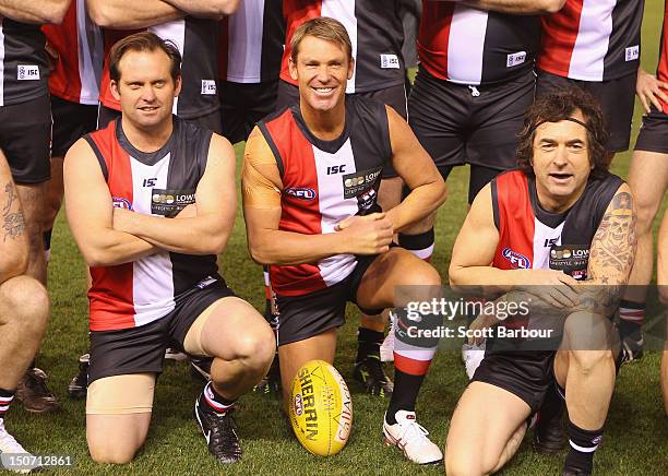 Shane Warne poses for a team photograph before playing a game of Aussie Rules football as he takes part in the St Kilda Thank You Round charity match...