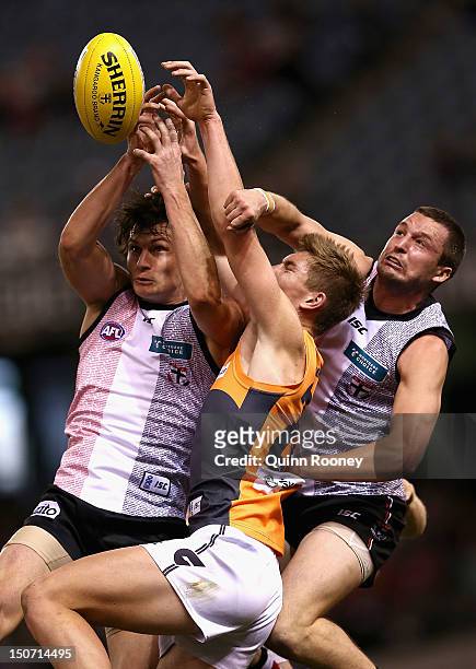 Tom Simpkin of the Saints marks infront of Adam Tomlinson of the Giants during the round 22 AFL match between the St Kilda Saints and the Greater...
