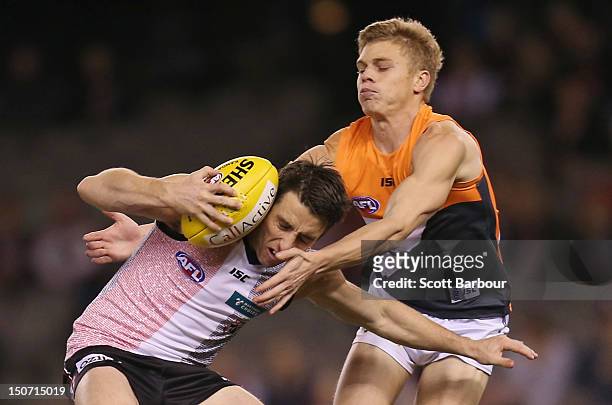Stephen Milne of the Saints is tackled during the round 22 AFL match between the St Kilda Saints and the Greater Western Sydney Giants at Etihad...