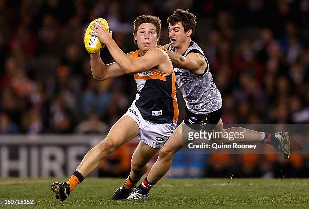 Toby Greene of the Giants avoids a tackle during the round 22 AFL match between the St Kilda Saints and the Greater Western Sydney Giants at Etihad...