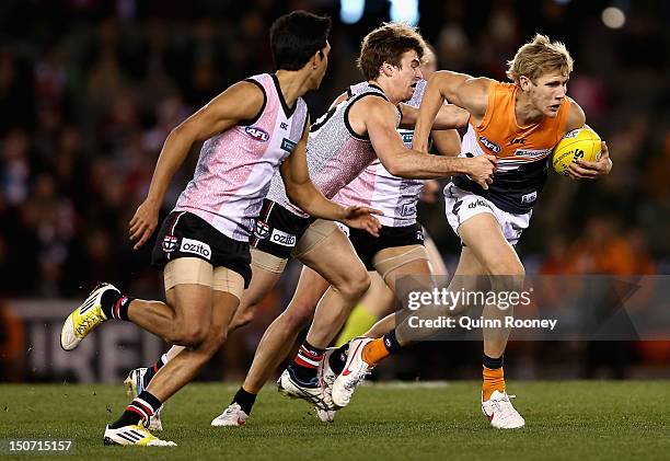 Nick Haynes of the Giants breaks through a tackle during the round 22 AFL match between the St Kilda Saints and the Greater Western Sydney Giants at...