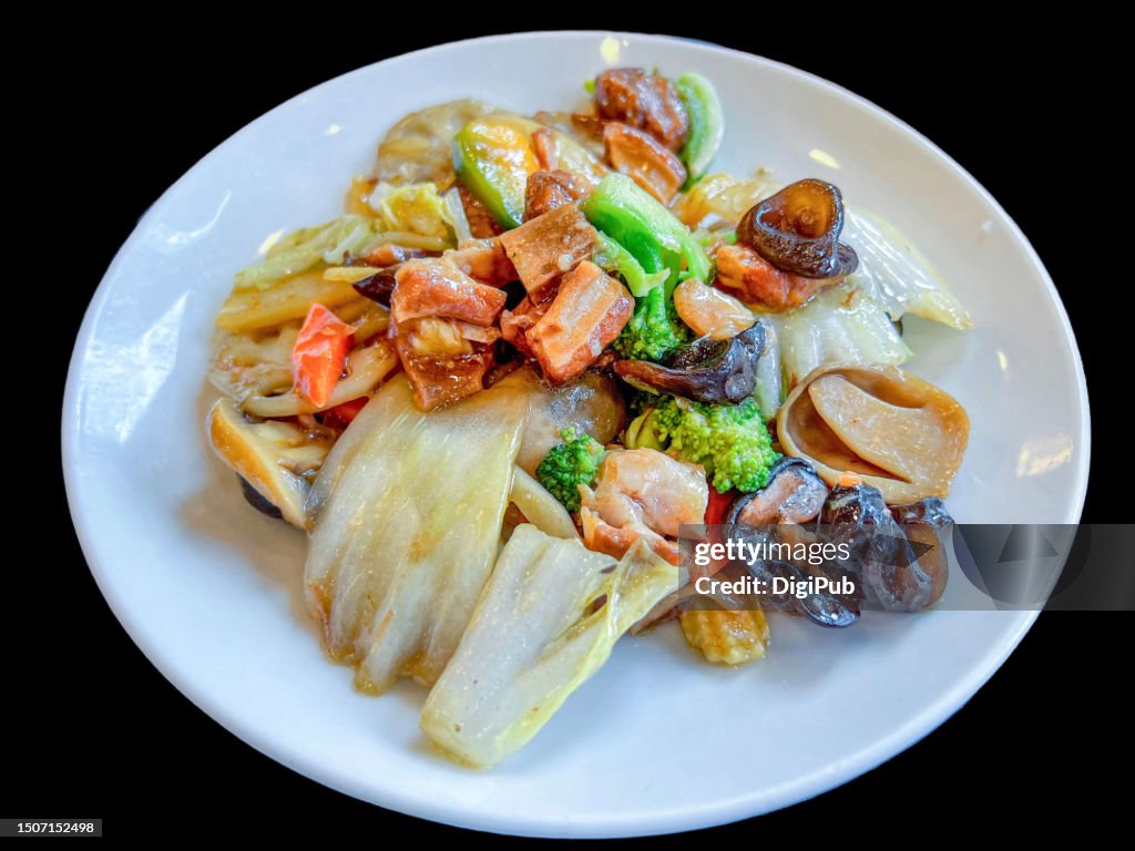 Chuka spareribs and vegetables isolated against black background