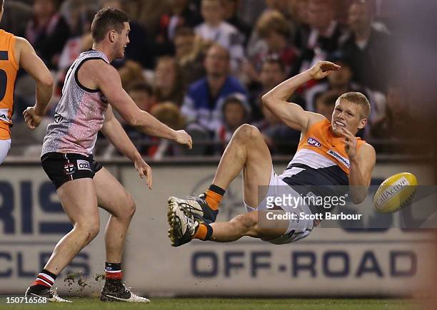 Adam Treloar of the Giants is tackled during the round 22 AFL match between the St Kilda Saints and the Greater Western Sydney Giants at Etihad...