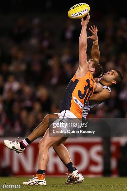 Taylor Adams of the Giants and Ahmed Saad of the Saints contest for a mark during the round 22 AFL match between the St Kilda Saints and the Greater...