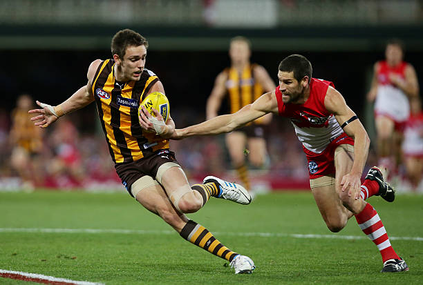 Jack Gunston of the Hawks is challenged by Martin Mattner of the Swans during the round 22 AFL match between the Sydney Swans and the Hawthorn Hawks...