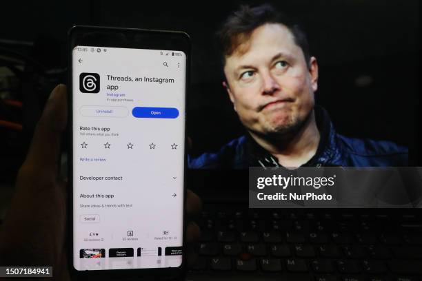 Man shows the newly introduced ''Threads'' app with an Elon Musk background on July 6 in Colombo, Sri Lanka.