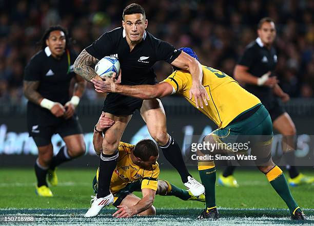 Sonny Bill Willams of the All Blacks looks to beat the tackle of Quade Cooper and Nathan Sharpe of the Wallabies during The Rugby Championship...