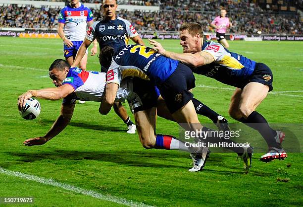 Timana Tahu of the Knights scores a try during the round 25 NRL match between the North Queensland Cowboys and the Newcastle Knights at Dairy Farmers...
