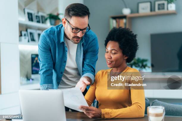 couple doing their budget at home - financial planning couple stock pictures, royalty-free photos & images