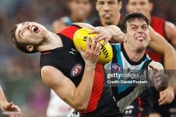Zach Merrett of the Bombers and Zak Butters of the Power contest the ball during the round 16 AFL match between Essendon Bombers and Port Adelaide...