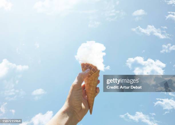creative picture of an ice cream cone made of cloud. - kegel stock-fotos und bilder