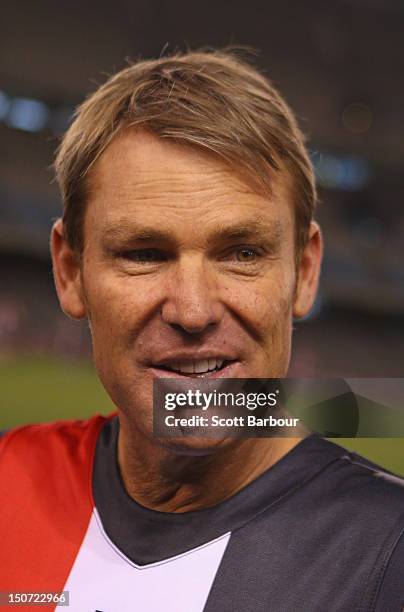 Shane Warne talks with Nick Riewoldt of the Saints before playing a game of Aussie Rules football as he takes part in the St Kilda Thank You Round...