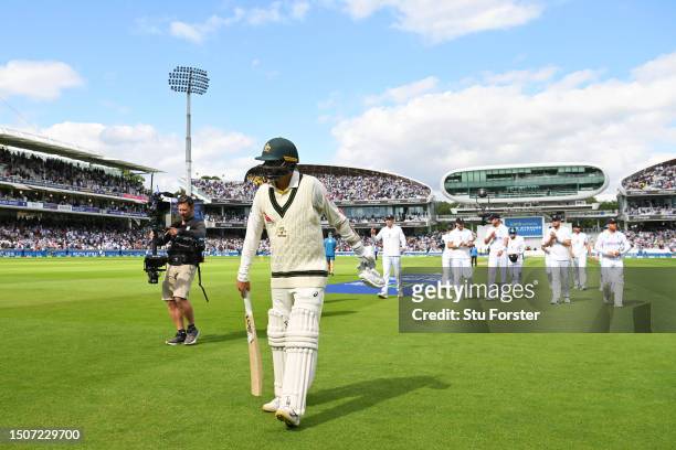 Nathan Lyon of Australia and England players walk off the field after he is dismissed by Stuart Broad of England as England during Day Four of the...