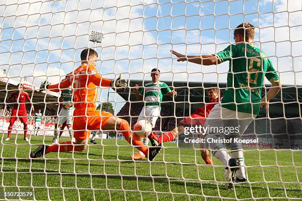 Thomas Mueller of Bayern scores the first goal against Max Gruen , Edgar Prib and Heinrich Schmidtgal of Fuerth during the Bundesliga match between...