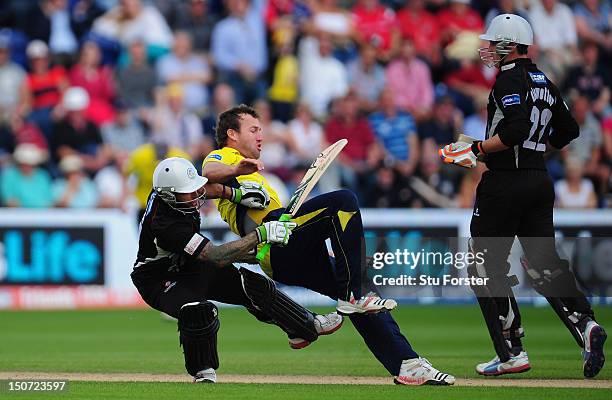 Somerset batsman Peter Trego crashes into Hampshire bowler Sean Ervine who had just trapped him lbw during the Friends Life T20 Semi Final between...