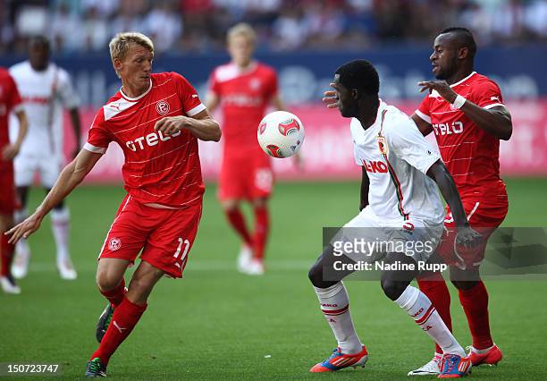 Axel Bellinghausen and Nando Rafael of Fortuna battles for the ball with Gibril Sankoh of FCA during the Bundesliga match between FC Augsburg v...
