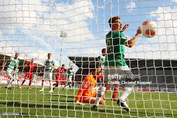 Thomas Mueller of Bayern has scored his first goal against Max Gruen and Heinrich Schmidtgal of Fuerth during the Bundesliga match between Greuther...