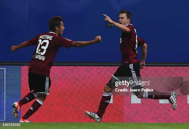 Hanno Balitsch of Nuernberg celebrates with his team mate Hiroshi Kiyotake after scoring his team's first goal during the Bundesliga match between...