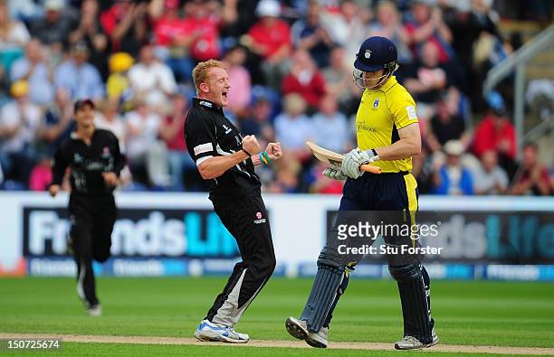 Hampshire batsman Jimmy Adams leaves the field as Somerset bowler Steve Kirby celebrates his wicket during the Friends Life T20 Semi Final between...