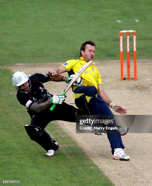 Sean Ervine of Hampshire collides with Peter Trego of Somerset during the Friends Life T20 Semi Final match between Hampshire and Somerset at the...