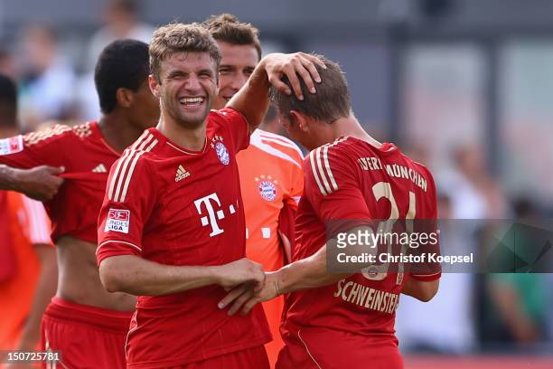 Thomas Mueller and Bastian Schweinsteiger of Bayern celebrate the 3-0 victory after the Bundesliga match between Greuther Fuerth and FC Bayern...